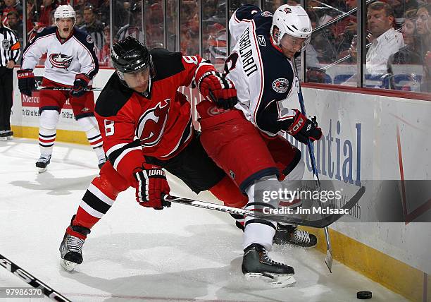 Anton Stralman of the Columbus Blue Jackets plays the puck against Dainius Zubrus of the New Jersey Devils at the Prudential Center on March 23, 2010...