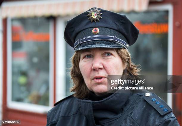 March 2018, Germany, Hiddensee: Island police officer Martina Dominik speaking with islanders in the town of Vitte on the Baltic Sea island of...
