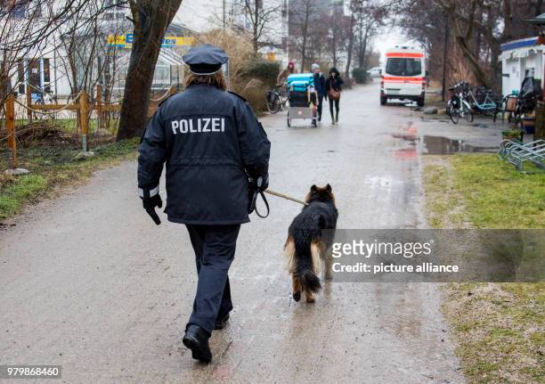 March 2018, Germany, Hiddensee: Island police officer Martina Dominik and her German Shepherd dog Maggie on patrol in the town of Vitte on the Baltic...