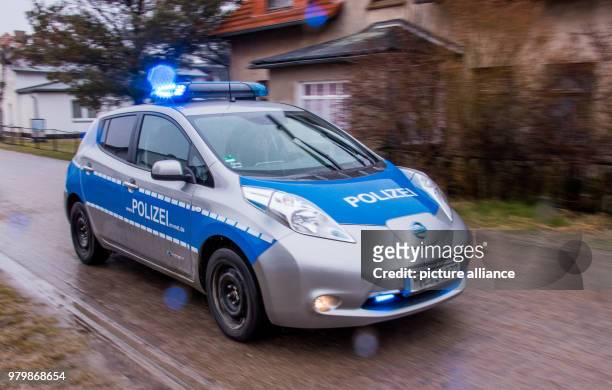 March 2018, Germany, Hiddensee: Island police officer Martina Dominik driving her electric patrol car in the town of Vitte on the Baltic Sea island...