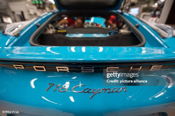 January 2018, Germany, Stuttgart: A worker fitting a Porsche 718 Cayman at the Porsche main factory. Photo: Marijan Murat/dpa