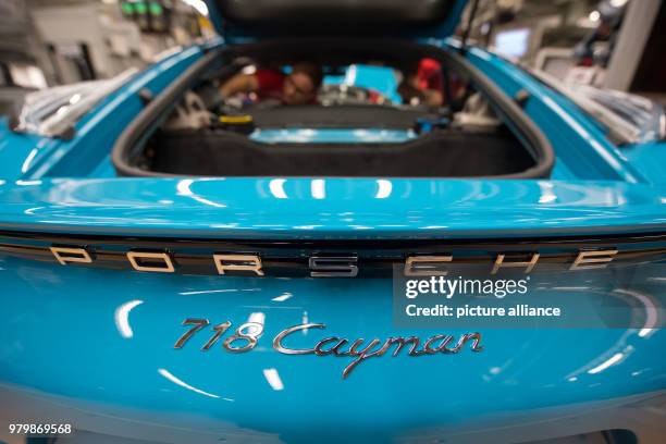 January 2018, Germany, Stuttgart: A worker fitting a Porsche 718 Cayman at the Porsche main factory. Photo: Marijan Murat/dpa