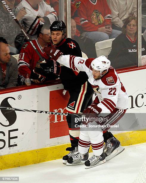 Brent Seabrook of the Chicago Blackhawks is checked into the glass by Lee Stempniak of the Phoenix Coyotes at the United Center on March 23, 2010 in...