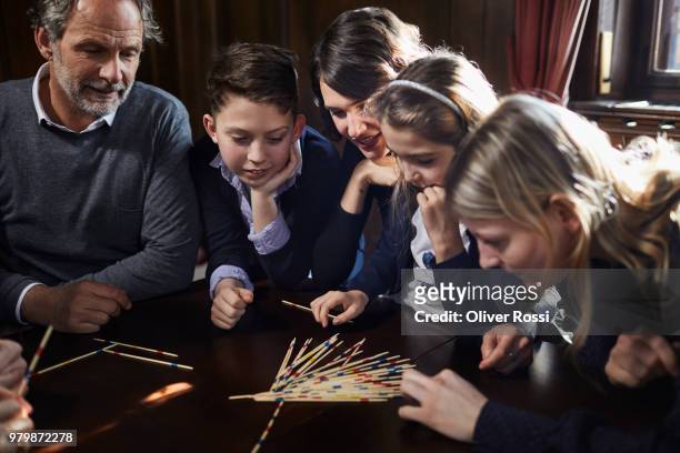 family playing mikado together - mikado stock pictures, royalty-free photos & images