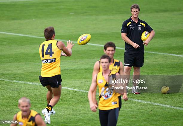 Damien Hardwick, coach of the Tigers, watches his players during a Richmond Tigers AFL training session at Punt Road Oval on March 24, 2010 in...