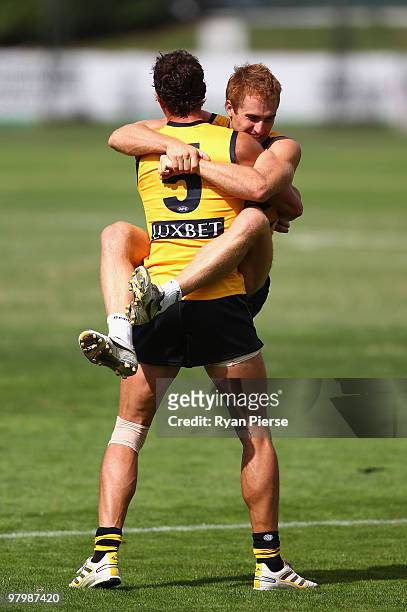 Daniel Jackson and Troy Simmonds of the Tigers wrestle during a Richmond Tigers AFL training session at Punt Road Oval on March 24, 2010 in...