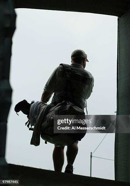 Tour caddies leave the 18th green tunnel after first-round play at the FedEx St. Jude Classic May 27, 2004 at the Tournament Players Club Southwind,...