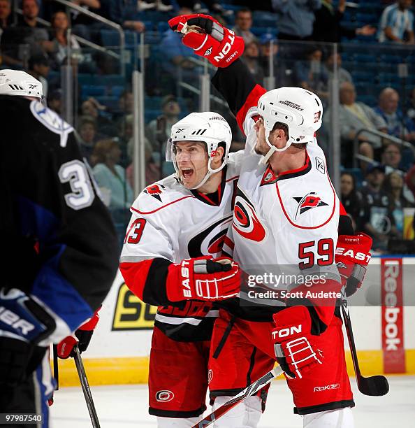 Chad LaRose of the Carolina Hurricanes celebrates his goal with teammate Ray Whitney who assisted against the Tampa Bay Lightning at the St. Pete...