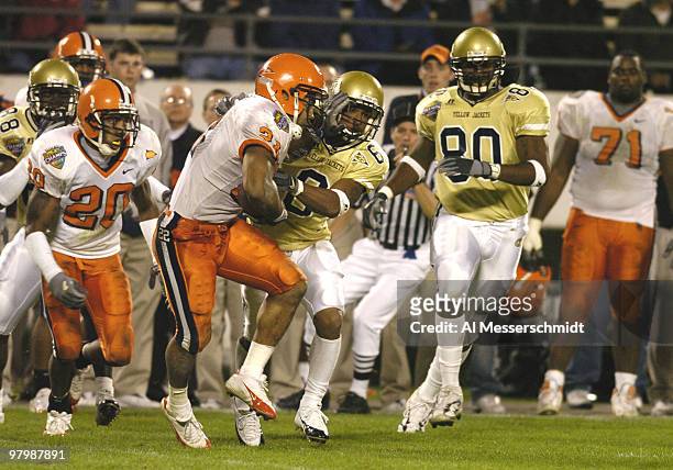Georgia Tech wide receiver Chris Dunlap battles Syracuse safety O'Neil Scott for the ball in the Champs Sports Bowl at the Florida Citrus Bowl,...