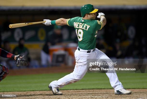 Josh Phegley of the Oakland Athletics bats against the Los Angeles Angels of Anaheim in the bottom of the seventh inning at the Oakland Alameda...