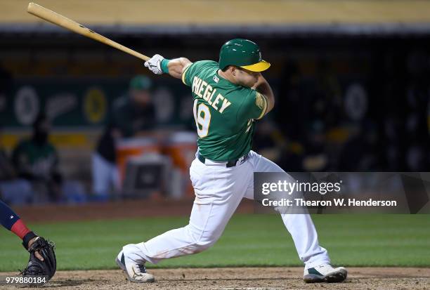 Josh Phegley of the Oakland Athletics bats against the Los Angeles Angels of Anaheim in the bottom of the seventh inning at the Oakland Alameda...