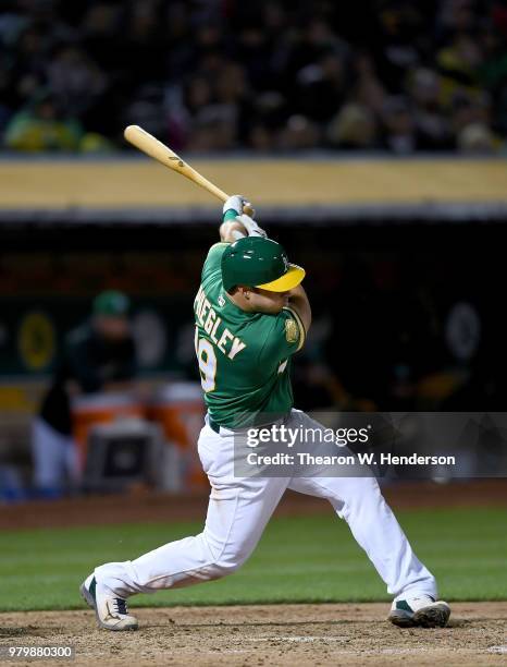 Josh Phegley of the Oakland Athletics bats against the Los Angeles Angels of Anaheim in the bottom of the seventh inning at the Oakland Alameda...