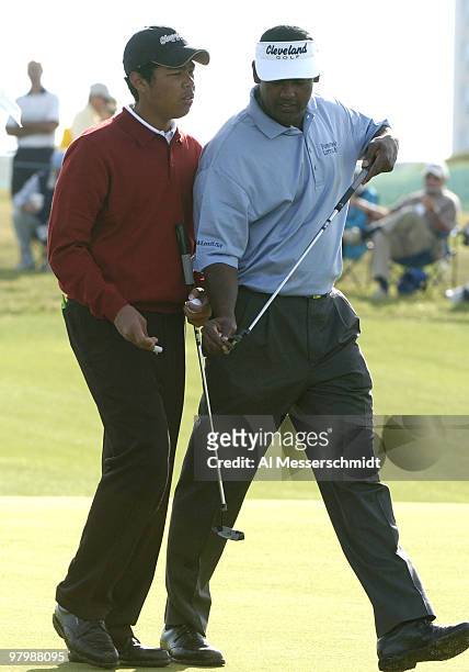 Qass and Vijay Singh set to putt during final-round play in the Office Deport Father/Son Challenge at ChampionsGate Resort near Orlando, Florida...