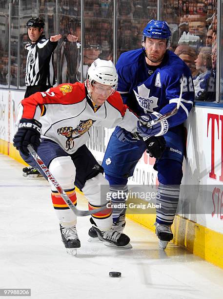 Keith Ballard of the Florida Panthers battles for the puck with Francois Beauchemin of the Toronto Maple Leafs during game action March 23, 2010 at...