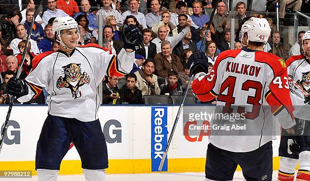 David Booth and Dmitry Kulikov of the Florida Panthers celebrate a third-period goal against the Toronto Maple Leafs during game action March 23,...