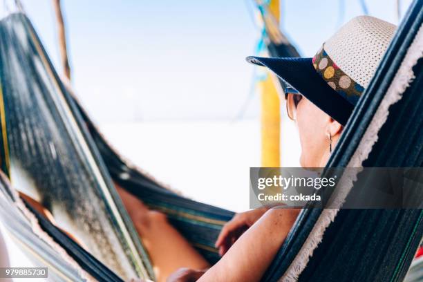 woman resting on hammock - lencois maranhenses national park stock pictures, royalty-free photos & images