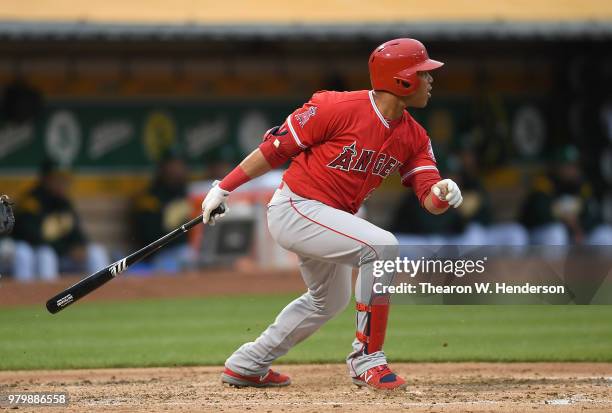 Jose Fernandez of the Los Angeles Angels of Anaheim hits an rbi single scoring Justin Upton against the Oakland Athletics in the top of the third...