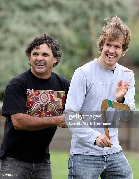 Red Bull Racing driver Sebastian Vettel of Germany has a boomerang throwing lesson from Ron Murray on March 24, 2010 in Melbourne, Australia.