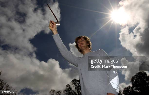 Red Bull Racing driver Sebastian Vettel of Germany has a boomerang throwing lesson from Ron Murray on March 24, 2010 in Melbourne, Australia.