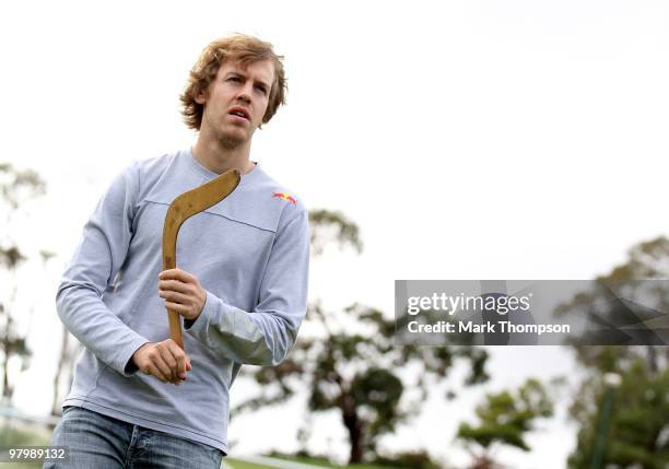 Red Bull Racing driver Sebastian Vettel of Germany has a boomerang throwing lesson from Ron Murray on March 24, 2010 in Melbourne, Australia.