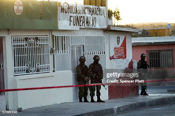 Military police stand guard at the scene of a murder of four people at a funeral home on March 23, 2010 in Juarez, Mexico. Secretary of State Hillary...