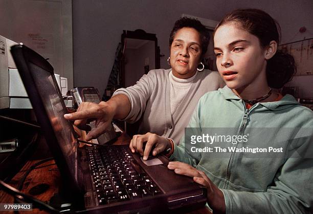 Judy Fisher and her 12-year-old-daughter Adjua at their computer in their N.W. Washington apartment. They do not use the AOL parental controls at...