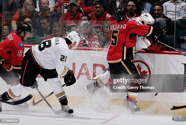 Mark Giordano and Cory Sarich of the Calgary Flames skate against Kyle Chipchura of the Anaheim Ducks on March 23, 2010 at Pengrowth Saddledome in...