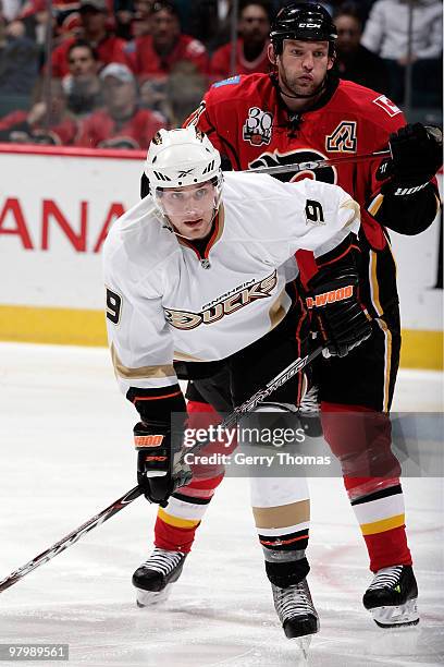 Robyn Regehr of the Calgary Flames checks Bobby Ryan of the Anaheim Ducks on March 23, 2010 at Pengrowth Saddledome in Calgary, Alberta, Canada.