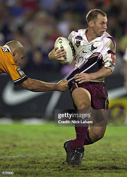 Brendon Reeves of the Eagles evades the tackle of Tyran Smith of the Tigers during the round 8 NRL match between the Northern Eagles and the Wests...
