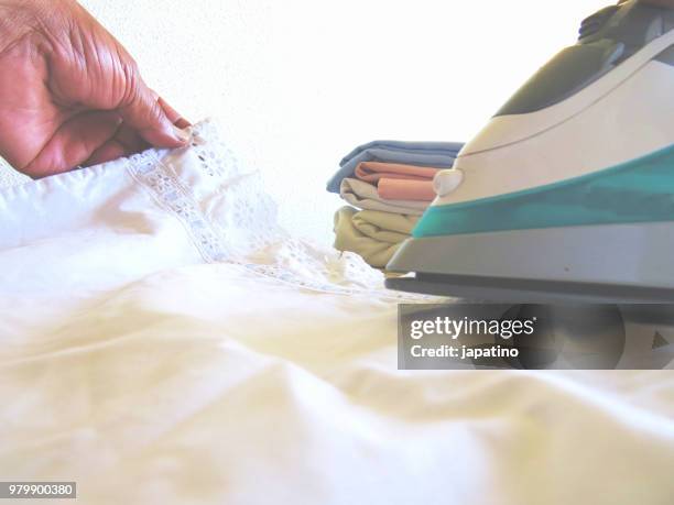 homework. ironing of clothes on ironing board - pantalón decorado fotografías e imágenes de stock