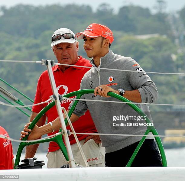 Formula One driver Lewis Hamilton takes control of the former America's Cup yacht 'The Spirit' under the watchful eye of Australian sailing legend...