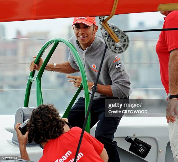 Formula One driver Lewis Hamilton takes control of the former America's Cup yacht 'The Spirit' under the watchful eye of Australian sailing legend...