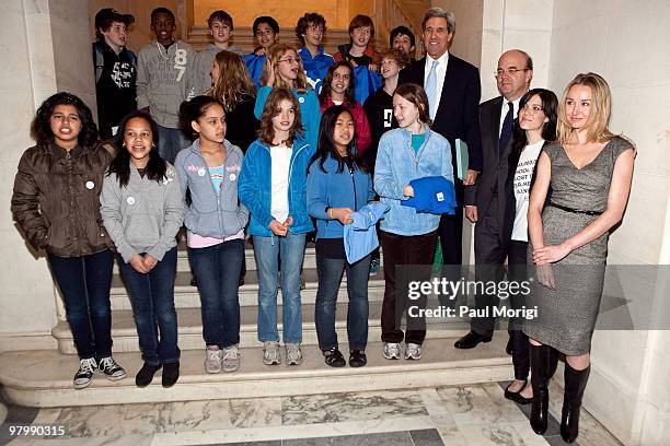 On right, Sen. John Kerry , Rep. Jim McGovern , Mandy Moore and Alexandra Cousteau pose for a photo with children during a photo op in the Russell...