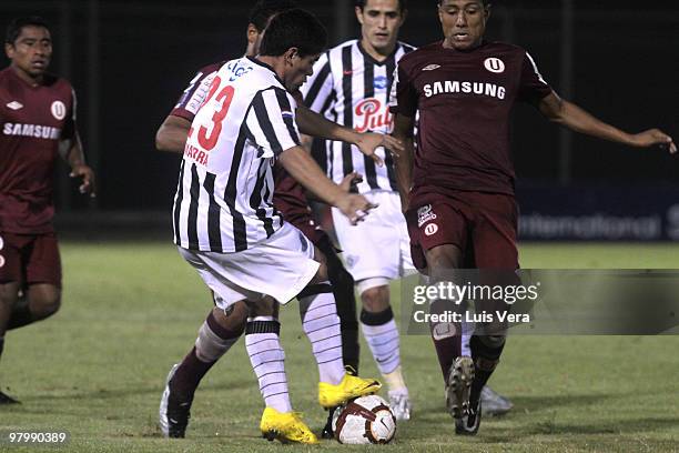 Peruvian Universitario de Lima's Luis Ramirez vies for the ball with Rodolfo Gamarra of Paraguay?s Libertad during their Copa Santander Libertadores...