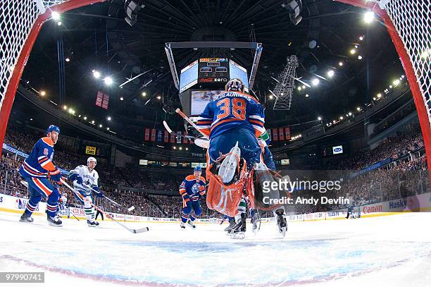 Jeff Deslauriers of the Edmonton Oilers jumps to make a save against the Vancouver Canucks at Rexall Place on March 23, 2010 in Edmonton, Alberta,...