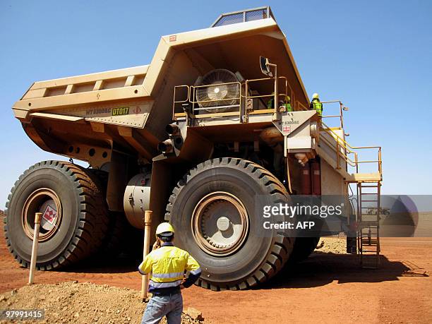 This photo taken on March 5, 2010 shows Sino Iron worker Darrell Lim , in front of a massive dump truck at Citic Pacific Mining's Sino Iron magnetite...