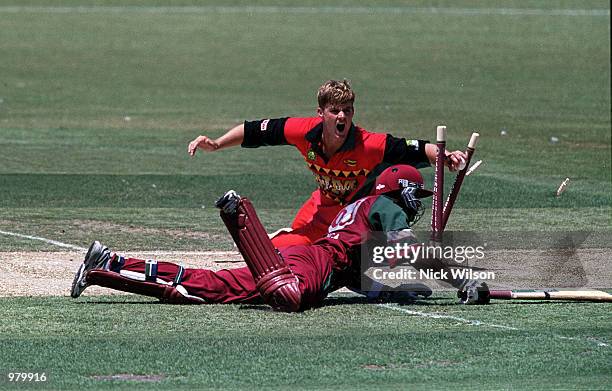 Bryan Strang of Zimbabwe runs out Daren Ganga of the West Indies for six during the Carlton Series One Day International between West Indies and...