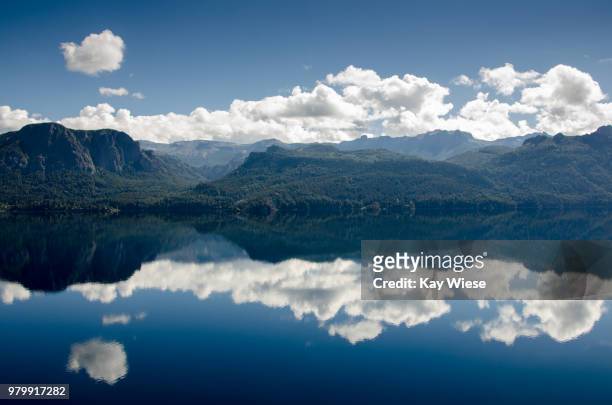 mountains and clouds reflecting in nahuel huapi lake, bariloche, rio negro province, argentina - see nahuel huapi stock-fotos und bilder
