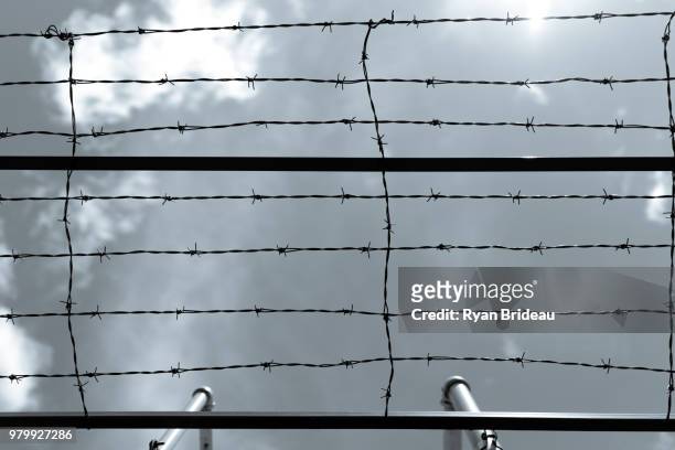 barbed wire sky - concentration camp stock pictures, royalty-free photos & images
