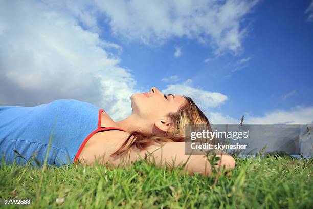 relaxation on field. - girl lying down stock pictures, royalty-free photos & images