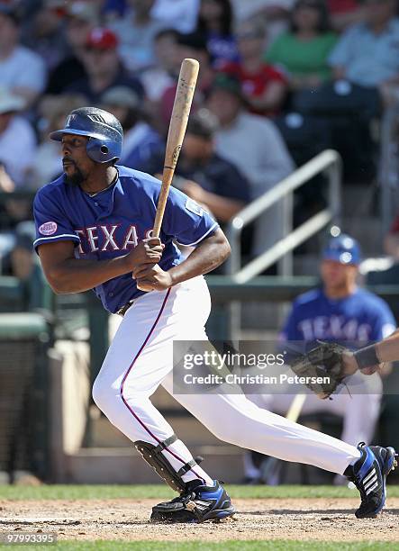 Vladimir Guerrero of the Texas Rangers bats against the Cleveland Indians during the MLB spring training game at Surprise Stadium on March 19, 2010...