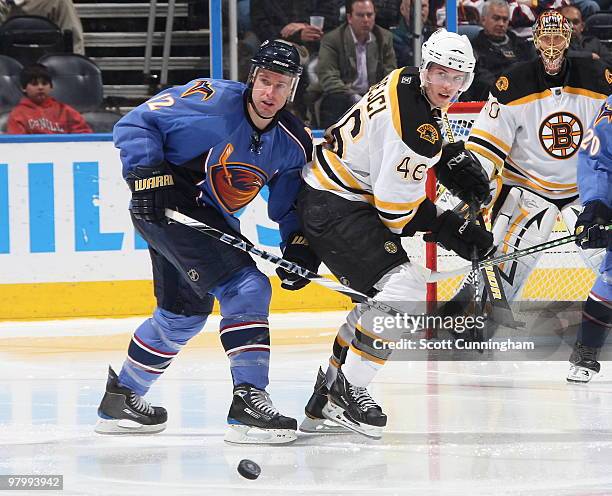 Todd White of the Atlanta Thrashers battles for the puck against David Krejci of the Boston Bruins at Philips Arena on March 23, 2010 in Atlanta,...