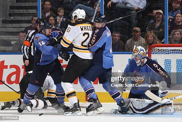 Todd White, Ron Hainsey, and goalie Johan Hedberg of the Atlanta Thrashers defend against Blake Wheeler of the Boston Bruins at Philips Arena on...