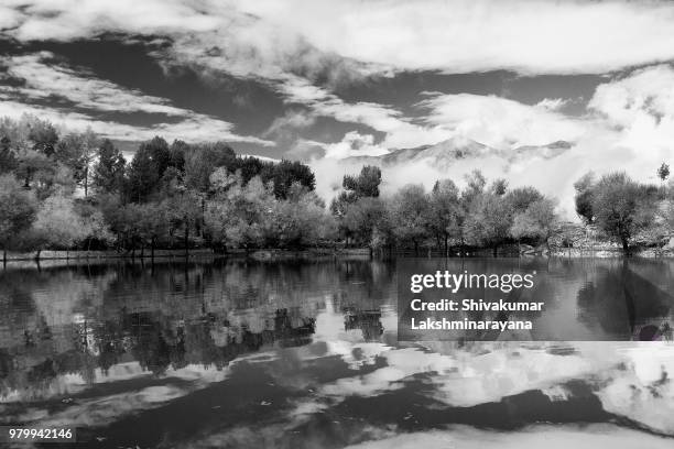 spiti mountains refelcted in nako lake, spiti valley, india. - refelcted stock pictures, royalty-free photos & images