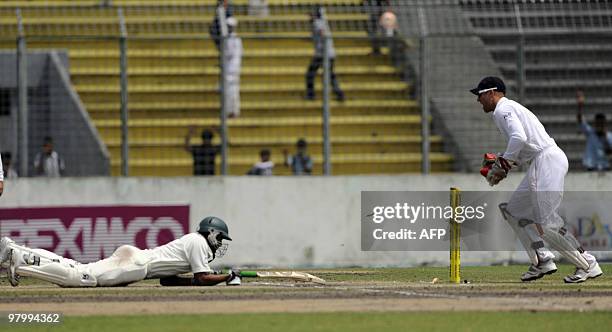 Bangladeshi cricket captain Shakib Al Hasan jumps to make his ground as England cricketer Matt Prior stumps during the fifth and last day of the...