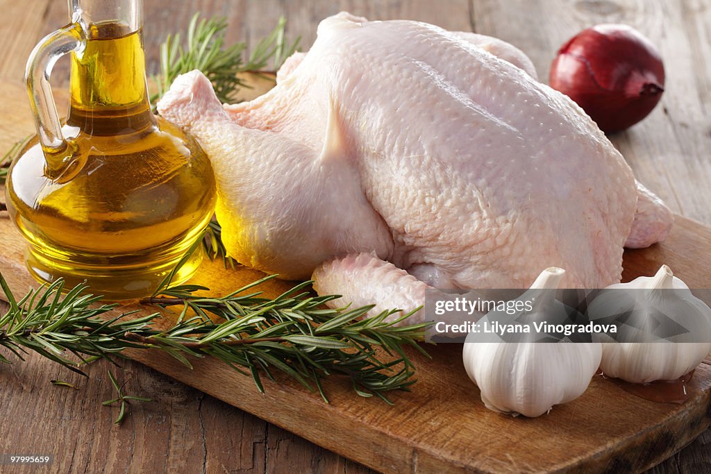 Raw chicken with rosemary, garlic, and olive oil