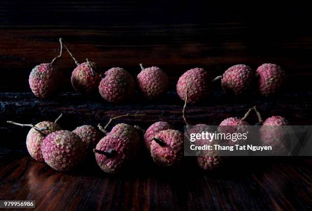 lychee on wooden background - leche stock pictures, royalty-free photos & images