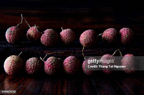 lychee on wooden background - leche stock pictures, royalty-free photos & images