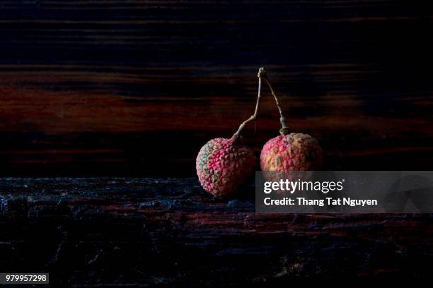 lychee on wooden background - leche stock pictures, royalty-free photos & images