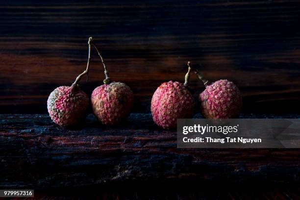 lychee on wooden background - leche stock pictures, royalty-free photos & images